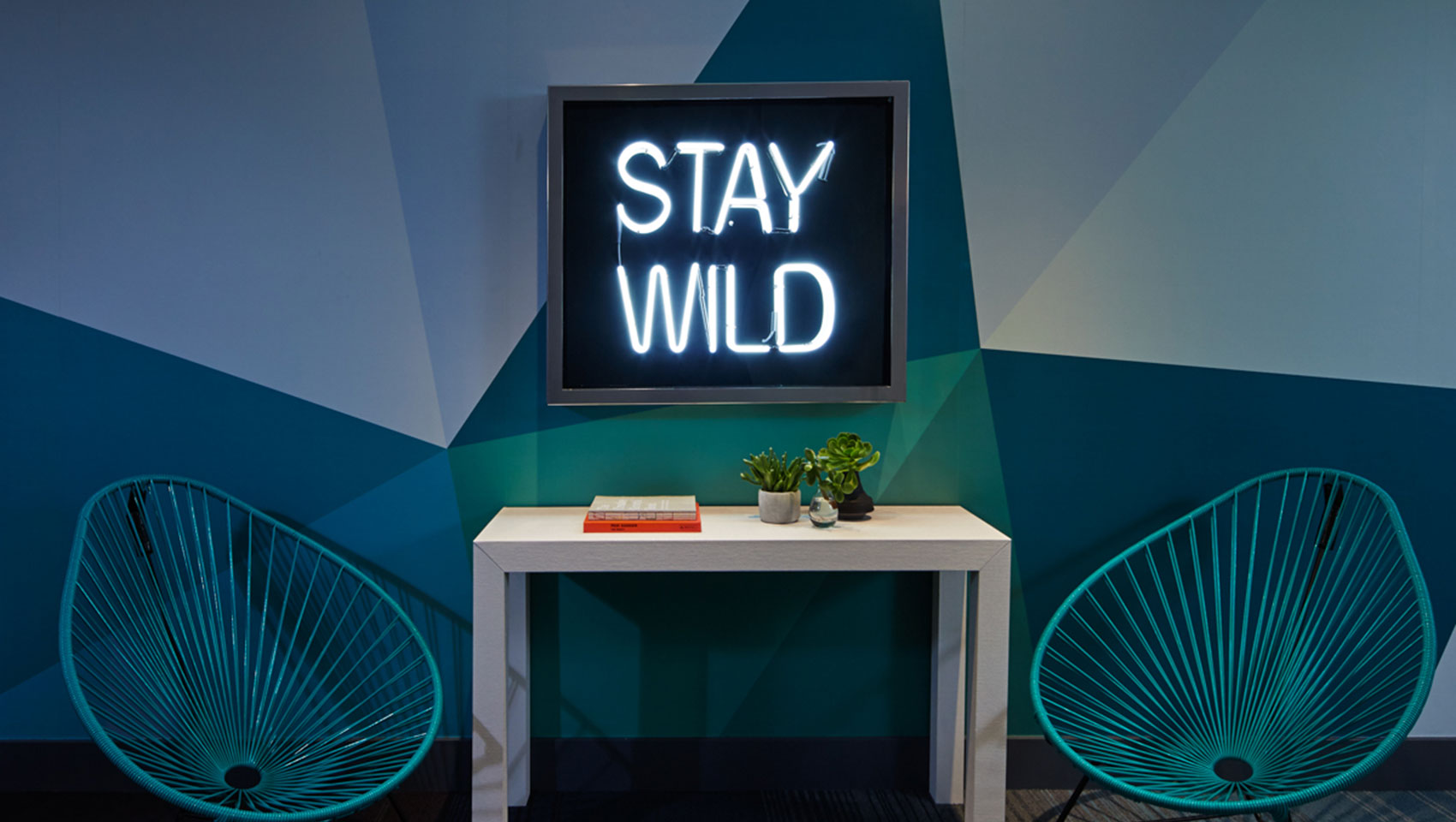 Stay Wild art piece and chairs at Kimpton Shorebreak Resort