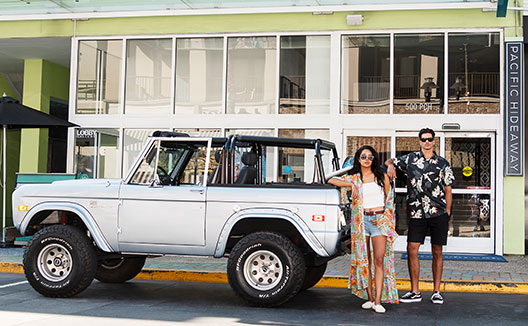 couple standing next to their car